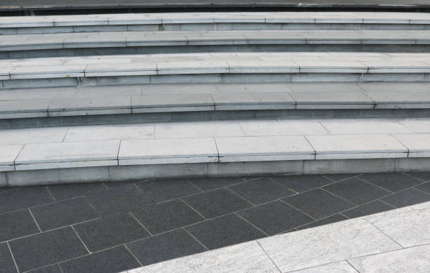 istock Dark gray granite tiles floor with white stairway. 1486944820