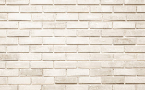 istock Empty background of wide cream brick wall texture. Beige old brown brick wall concrete or stone textured, wallpaper limestone abstract. Cream and white brick wall. Brickwork flooring pattern design. 1486944856