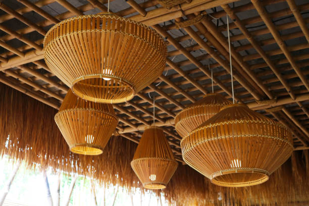 istock Wood pendant lamp tropical style installed on bamboo ceiling. 1486950876