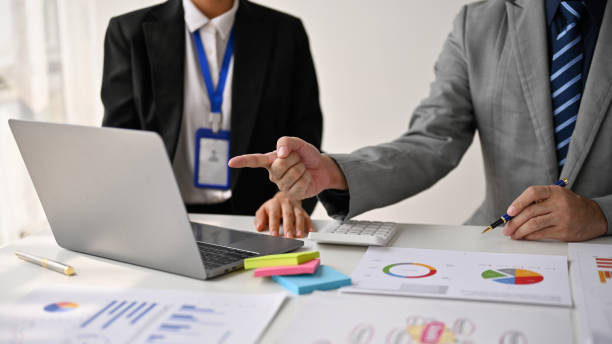 istock Professional male boss explaining the project and discussing a strategy plan with his team 1486957539