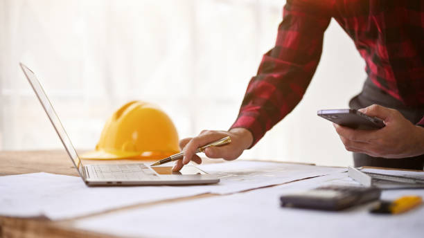 istock A professional male engineer working on his project on laptop in the office. 1486957637