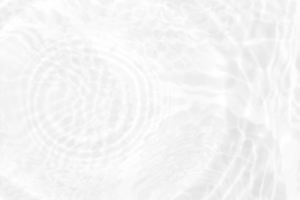 istock White water with ripples on the surface. Defocus blurred transparent white colored clear calm water surface texture with splashes and bubbles. Water waves with shining pattern texture background. 1486968320