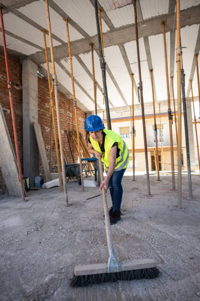 istock House construction, construction workers sweep the cement to remove the slag 1486971648