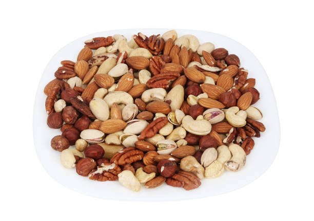 istock Mix of different nuts on a plate isolated 1486973291