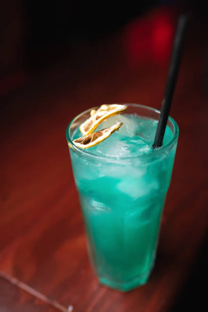 istock Summer cold blue lagoon cocktail with liquor, lemon slice, ice cubes 1486973928