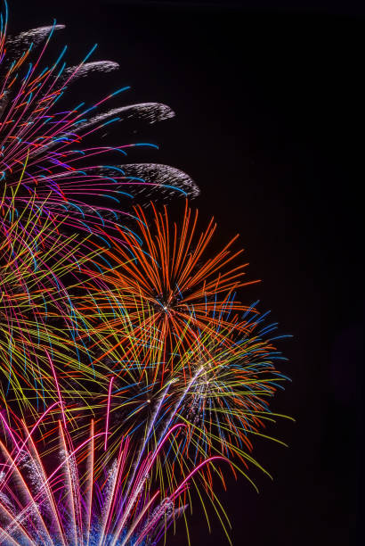 Bright Fireworks in the sky on black background vertical image stock photo