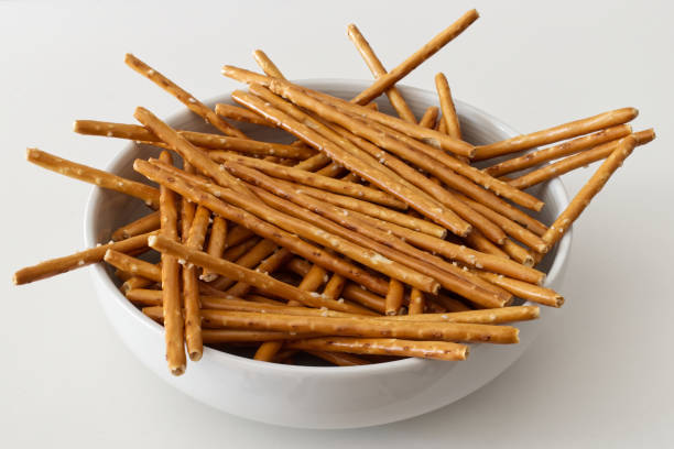 istock Salted pretzel sticks in a bowl isolated on white background 1486976190