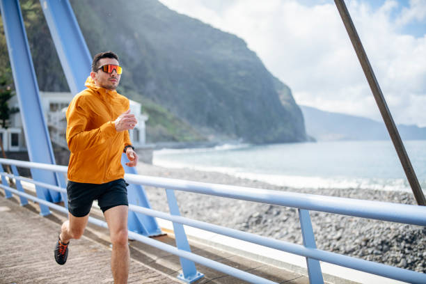 istock Man running on a bridge near the ocean. 1486989927