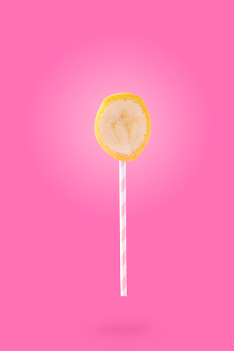 Strawberry, apple and banana represented as a lollipop