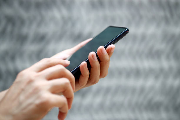 istock Woman hand using smartphone, typing messages on social network. 1486990323