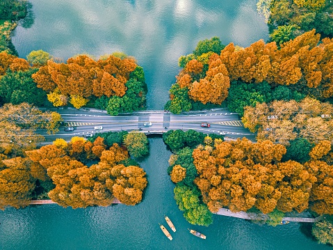 An aerial scenic view of a long bridge over river small boats in Hangzhou, China