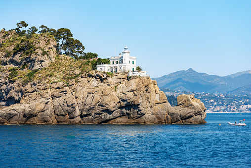 Portofino headland with the white lighthouse, Genoa province (Genova), Liguria, Italy, Europe. Rocky coast of the Mediterranean Sea (Ligurian Sea).
