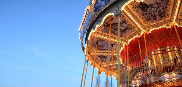 istock bright background, banner sky and carousel, amusement park, glowing carousel, blue sky 1486995455