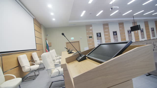 Digital equipment for speakers on table in conference hall