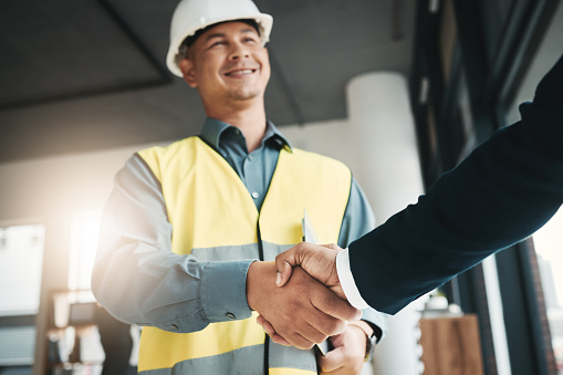 Handshake, partnership and collaboration of engineer in office for contract, deal or onboarding. Architecture, thank you and people shaking hands for hiring, recruitment or agreement, b2b or greeting