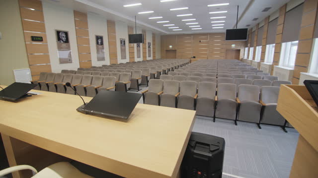 Monitors with mics on table and tribune in conference hall