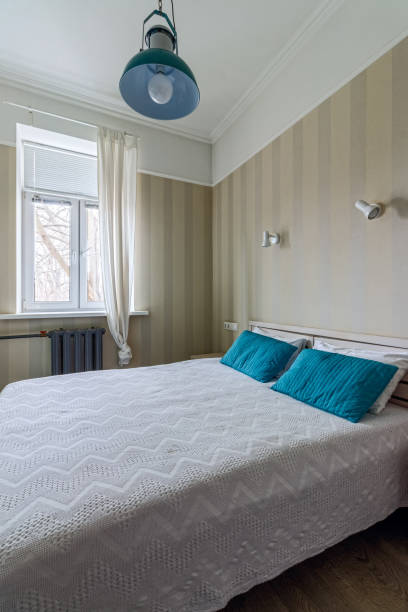 istock Bed in a small bedroom with turquoise pillows 1486997722