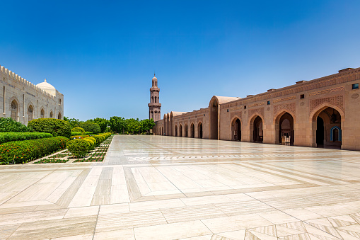 The Sultan Qaboos Grand Mosque is a stunning mosque located in Muscat, Oman. It was opened in 2001 and can accommodate up to 20,000 worshippers at a time, making it one of the largest mosques in the world.\n\nThe mosque is named after Sultan Qaboos bin Said al Said, who commissioned its construction. It features a blend of Islamic, Middle Eastern, and Omani architectural styles and boasts a number of impressive features, including a massive Swarovski crystal chandelier, the second largest hand-woven carpet in the world, and five minarets that rise up to a height of 90 meters.\n\nThe mosque is open to visitors of all faiths and is a popular tourist attraction in Oman. Visitors are asked to dress modestly and remove their shoes before entering the mosque. Guided tours are also available to provide more insight into the mosque's history and architecture.
