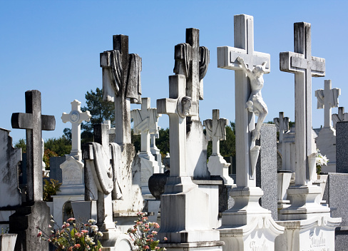 Ancient cemetery, group of white marble crosses  in the sunlight in Lugo city, Galicia, Spain.