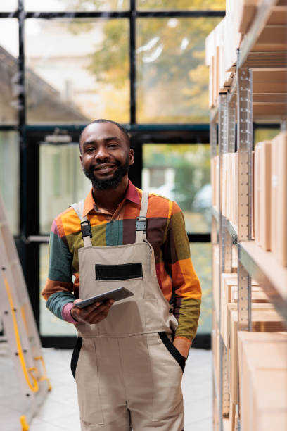 istock Warehouse employee standing near shelves full with boxes 1487001734