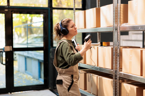 istock Small business employee scanning carton boxes barcode 1487002127