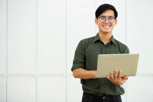 istock Young asian business man or student working online on computer laptop. 1487003822