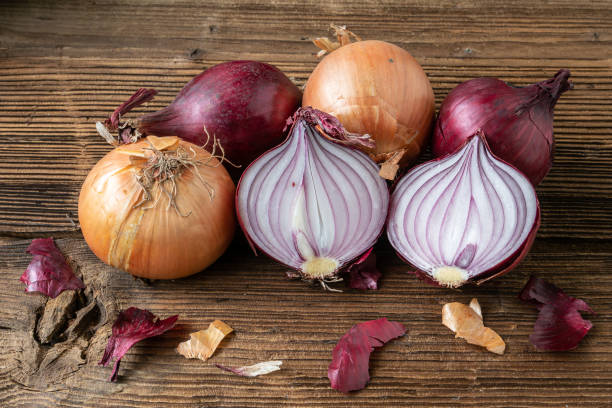 istock Yellow and red onions on a wooden board 1487005719