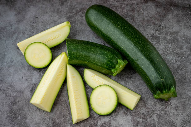 istock Fresh sliced zucchini on a black background 1487005767