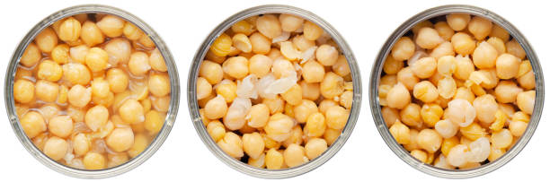 istock Flat lay view at opened tin can with chickpeas isolated on white background 1487006272