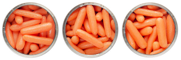 istock Flat lay view at opened tin can with carrots isolated on transparent background 1487006282