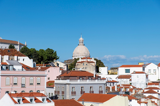 View over the colorful roofs of the Alfama neighborhood in Lisbon, Portugal with in the center the Church of Santa Engrácia (Igreja de Santa Engrácia), originally the National Pantheon