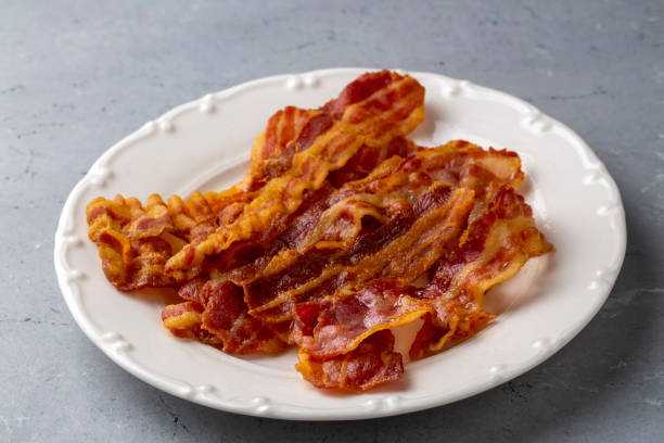 istock Delicious fried bacon served on plate. 1487006462