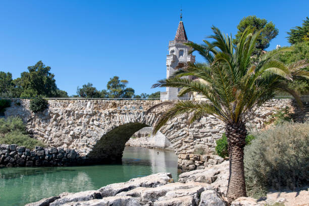View of stone bridge and water in front of Museum Condes de Castro Guimaraes in Cascais, Lisbon District, Portugal