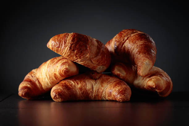 istock Freshly baked croissants on a black ceramic table. 1487007821