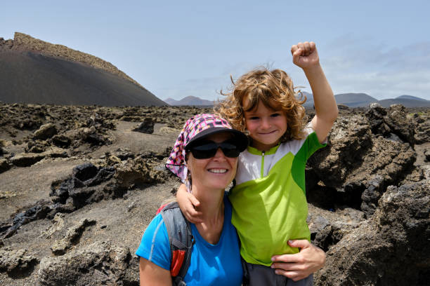 Mother and son taking a selfie while hiking between volcanoes. Lanzarote. Canary Islands stock photo