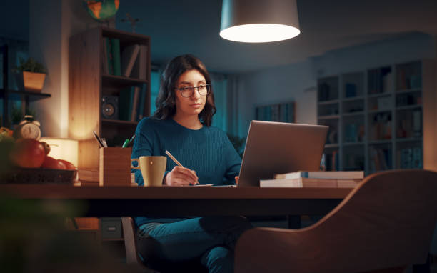 istock Woman studying late at night 1487010276