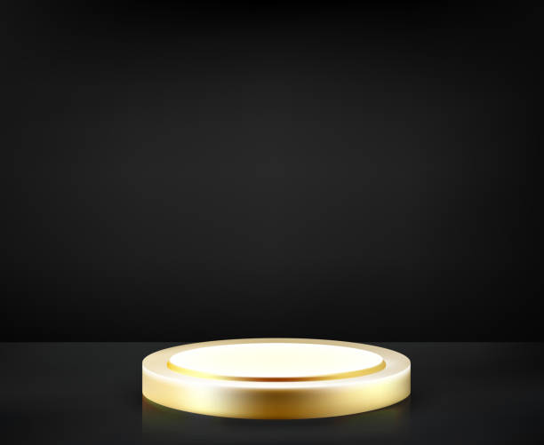 istock White and gold color podium in black studio. Premium product presentation. Minimal stage with podium. 1487010299