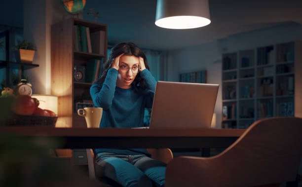 istock Exhausted woman connecting online at night 1487010304