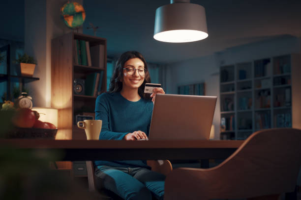 Woman doing online shopping at home stock photo