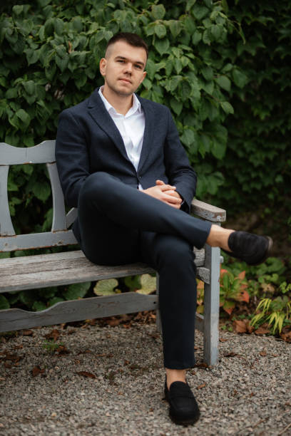 istock portrait of a young guy groom in a dark wool suit 1487011663