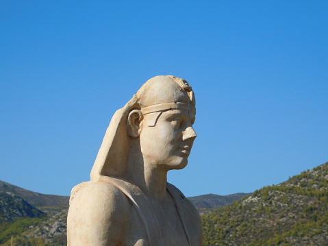 Head of a modern copy of an ancient statue of Egyptian God Osiris, in the 2nd century CE sanctuary, in Nea Makri, Attica, Greece