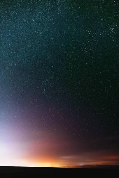 istock Night Dark Blue Sky Glowing Stars Background Backdrop With Sky Gradient. Colorful Night Starry Sky Gradient. Amazing Night View Sky. Bright Yellow And Orange Colors 1487013002
