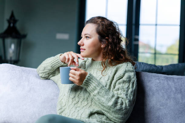 istock Young woman drinking a cup of coffee 1487013347