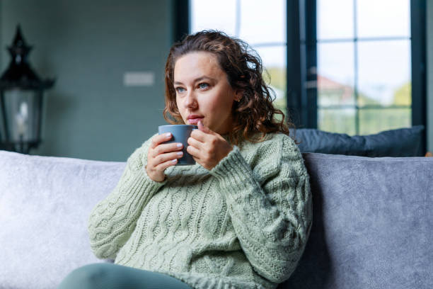 istock Young woman drinking a cup of coffee 1487013455