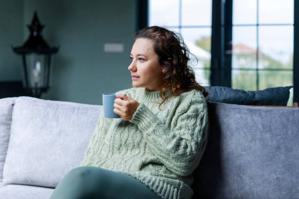 istock Young woman drinking a cup of coffee 1487014466