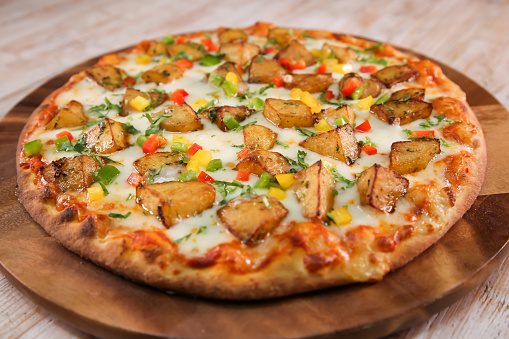 Batata harra pizza with potato served in cutting board isolated on background top view of fast food