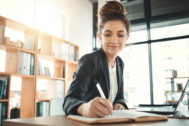 istock Planning, notes and woman with a notebook for a schedule, agenda and reminder. Idea, strategy and business employee writing in a journal to remember a task, memory or plan for a corporate project 1487015984