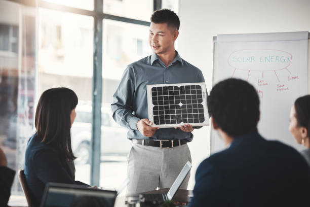 istock Solar panels, sustainability and man expert in presentation, pitch and conference about renewable energy meeting. Businessman, briefing and teaching corporate people sustainable electricity 1487016102