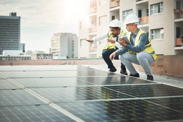istock Solar panels, teamwork and people with tablet for construction, maintenance and planning inspection. Sustainability, renewable energy and electricians with digital tech for photovoltaic electricity 1487016239