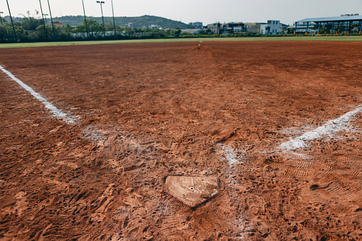 This refers to a home plate that has undergone baseball games or practices, bearing numerous footprints on its surface.